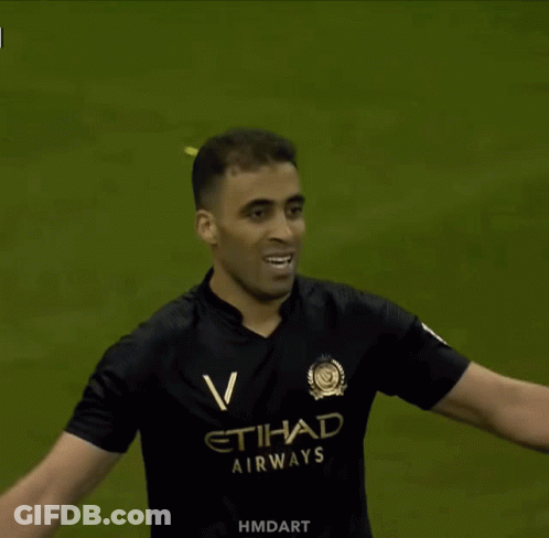 A Man In A Black Etihad Airways Jersey GIF