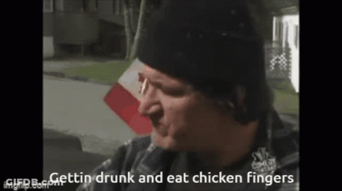 A Man In A Black Hat Is Eating Chicken Fingers . GIF
