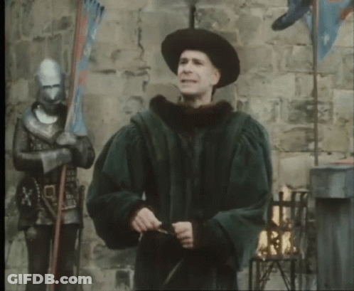 A Man In A Black Hat Is Holding A Sword GIF