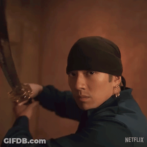 A Man In A Black Hat Is Holding A Sword With The Words " Good Sword " Above Him GIF