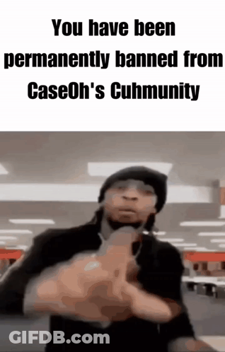 A Man In A Black Hat Is Pointing A Gun At The Camera . GIF