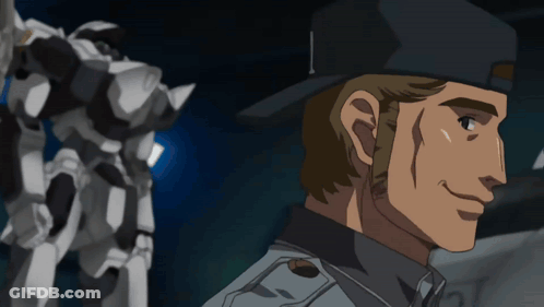 A Man In A Black Hat Is Smiling In Front Of A Robot GIF