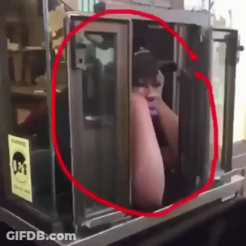 A Man In A Black Hat Is Standing In A Booth With A Sign That Says 031 GIF