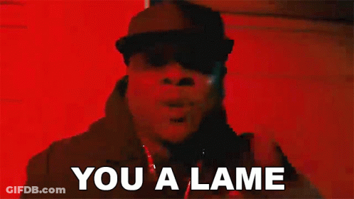 A Man In A Black Hat Is Standing In Front Of A Red Wall And Saying `` You A Lame '' . GIF