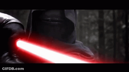 A Man In A Black Hood Is Holding A Red Lightsaber GIF