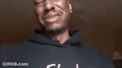 A Man In A Black Hoodie Is Crying While Holding His Hands To His Chest . GIF