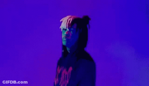 A Man In A Black Hoodie Is Making A Peace Sign With His Hands . GIF