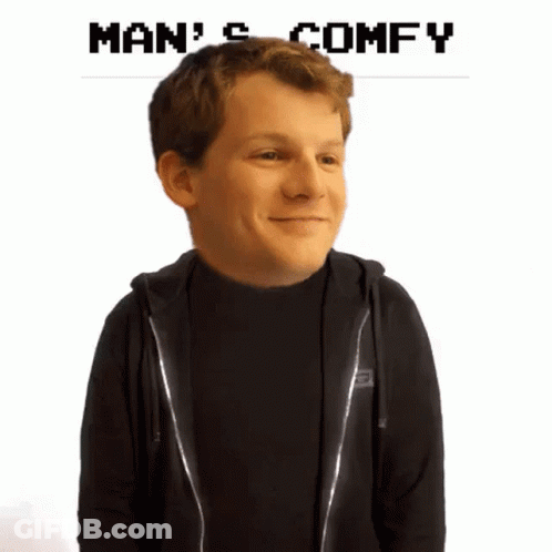 A Man In A Black Hoodie Is Smiling With The Words Man 'S Comfy Below Him GIF