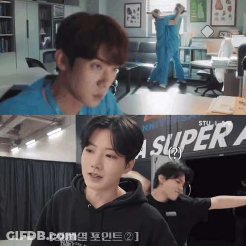 A Man In A Black Hoodie Is Standing In Front Of A Sign That Says Super A GIF
