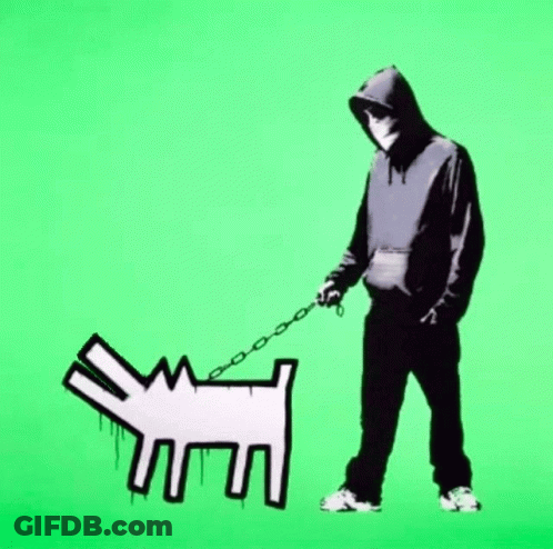 A Man In A Black Hoodie Is Walking A White Dog On A Leash GIF