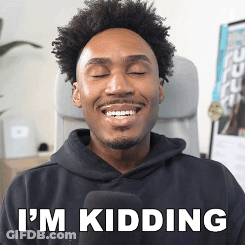 A Man In A Black Hoodie Says I 'M Kidding While Smiling GIF