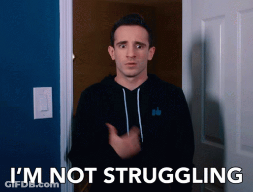 A Man In A Black Hoodie Says I 'M Not Struggling In Front Of A Blue Door GIF