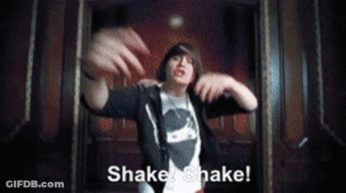 A Man In A Black Hoodie Says Shake Shake In A Dark Room GIF