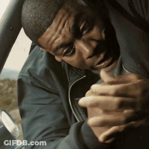 A Man In A Black Jacket Holds His Hands Together GIF