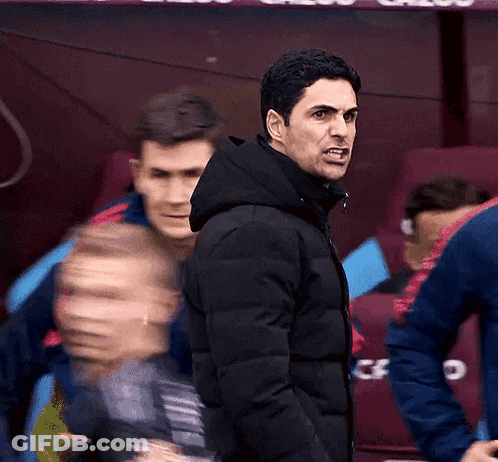 A Man In A Black Jacket Is Giving A Thumbs Up In Front Of A Banner That Says Cazoo GIF