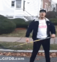 A Man In A Black Jacket Is Holding A Hula Hoop In Front Of A House GIF