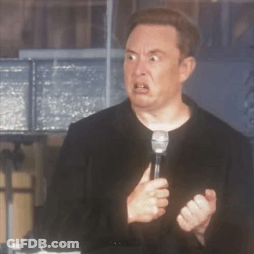 A Man In A Black Jacket Is Holding A Microphone And Making A Funny Face GIF