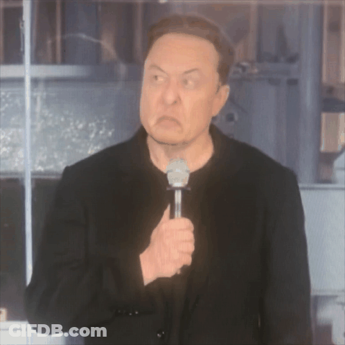 A Man In A Black Jacket Is Holding A Microphone And Making An Angry Face GIF