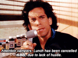 A Man In A Black Jacket Is Holding A Microphone And Says Attention Campers GIF