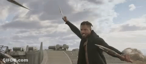 A Man In A Black Jacket Is Holding A Sword In His Hand . GIF