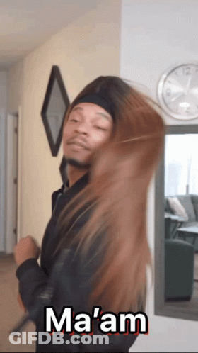 A Man In A Black Jacket Is Holding A Woman 'S Hair And Says Ma 'Am GIF