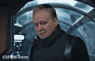 Man In Black Jacket Looks Serious At Camera GIF
