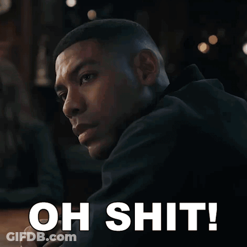 A Man In A Black Jacket Is Looking Over His Shoulder With The Words Oh Shit Written Below Him GIF