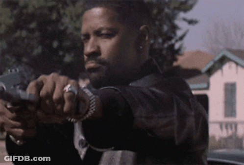 A Man In A Black Jacket Is Pointing A Gun At The Camera GIF
