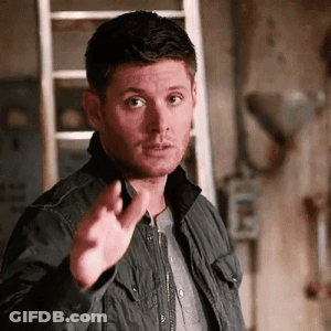 A Man In A Black Jacket Is Pointing His Finger At Something . GIF