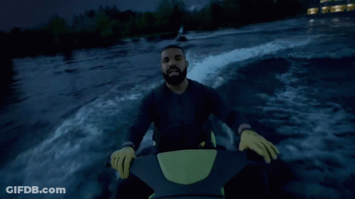 A Man In A Black Jacket Is Riding A Jet Ski GIF