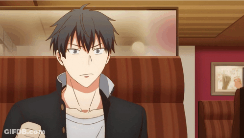 A Man In A Black Jacket Is Sitting In A Striped Chair GIF