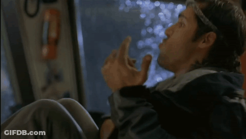 A Man In A Black Jacket Is Sitting On A Bus And Looking Out The Window . GIF