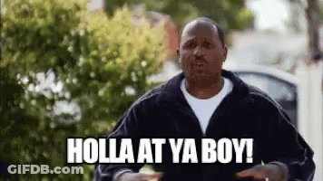 A Man In A Black Jacket Is Standing In Front Of A Car And Says Holla At Ya Boy . GIF