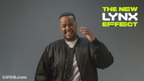 A Man In A Black Jacket Is Standing In Front Of A Sign That Says " The New Lynx Effect " GIF