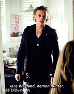 A Man In A Black Jacket Is Standing Next To A Woman And Says Jace Wayland Demon Hunter . GIF