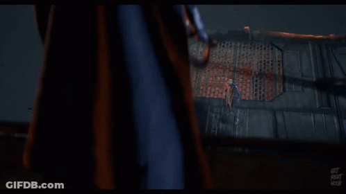 A Man In A Black Jacket Is Standing Next To Another Man In A Black Suit GIF