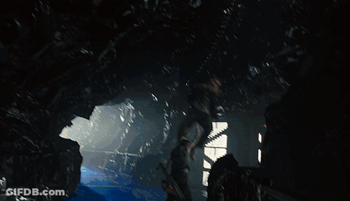 A Man In A Black Jacket Is Standing On A Blue Surface GIF