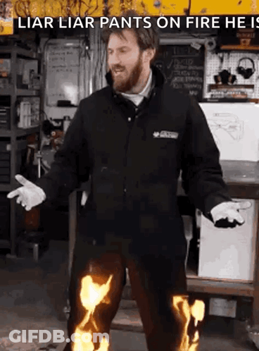 A Man In A Black Jacket Is Wearing Flaming Pants GIF