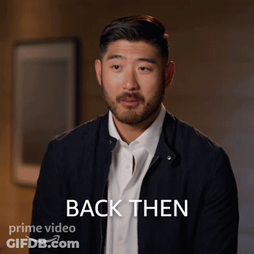 A Man In A Black Jacket Says " Back Then " In Front Of Him GIF