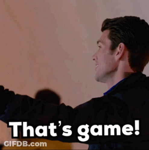 A Man In A Black Jacket Says That 'S Game While Standing In Front Of A Wall GIF