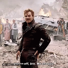 A Man In A Black Jacket Stands In Front Of A Group Of People And Says " Dance Off Bro Me And You " GIF