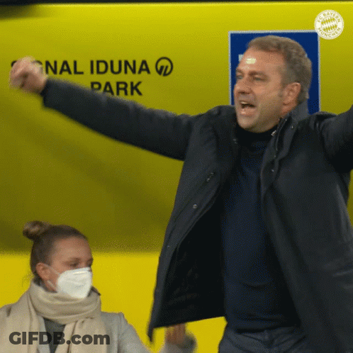 A Man In A Black Jacket Stands In Front Of A Sign That Says National Iduna Park GIF