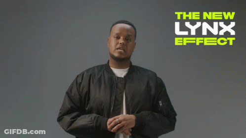 A Man In A Black Jacket Stands In Front Of A Sign That Says " The New Lynx Effect " GIF
