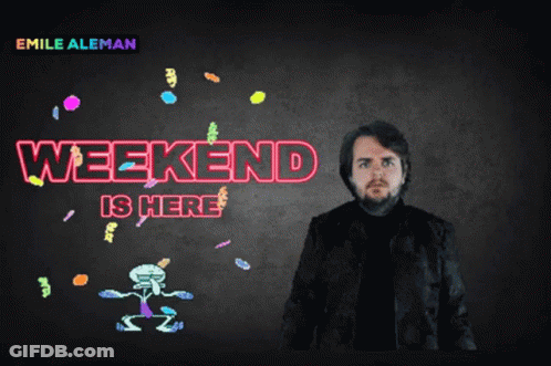 A Man In A Black Jacket Stands In Front Of A Sign That Says Weekend Is Here GIF
