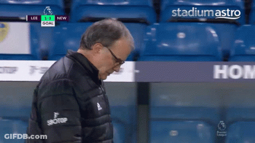 A Man In A Black Jacket Stands In Front Of Stadium Astro GIF