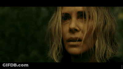A Man In A Black Jacket Stands In The Woods GIF