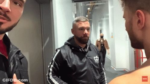 A Man In A Black Jacket With A Crown On It GIF