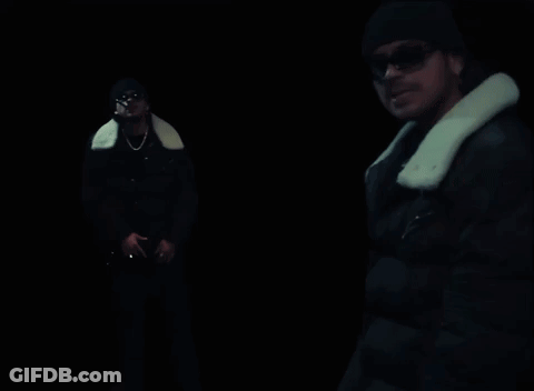 A Man In A Black Jacket With A White Fur Collar GIF