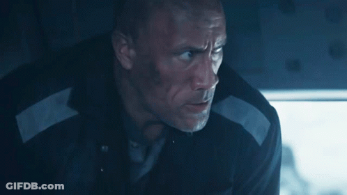 A Man In A Black Jacket With A White Stripe On The Sleeve Is Looking Down GIF