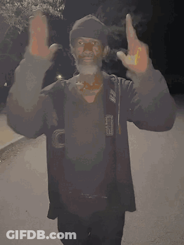 A Man In A Black Jacket With The Letter O On His Chest GIF